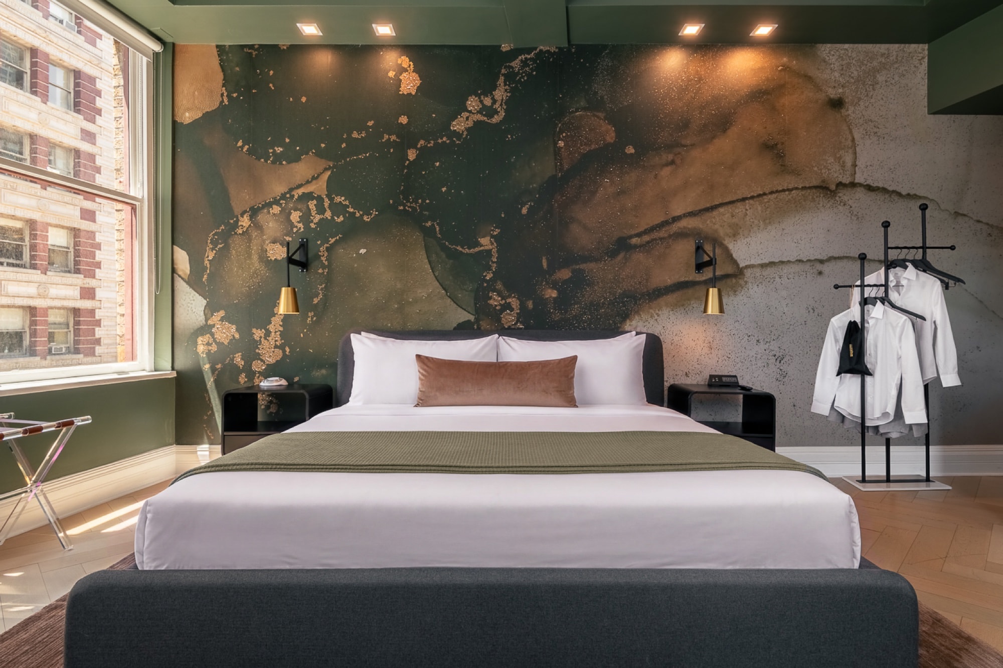 Room 1002, king bed beneath the hand-painted mural