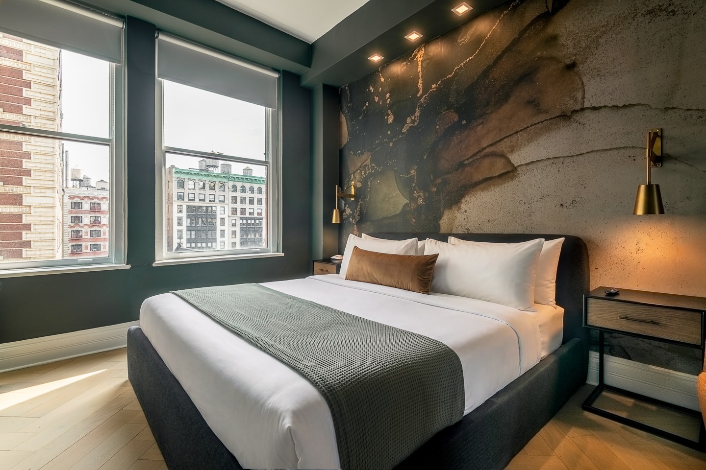 Room 1008, king bed against the green mural